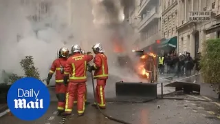 Firefighters rush to put out fire started during Paris protest