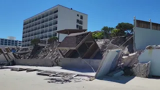 Hurricane Ian's destruction on Daytona Beach coast and pier area. A close up fly by from the beach.