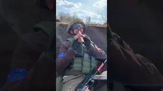 Ukrainian soldiers play in the trenches