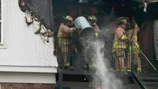 10 people safe after escaping house fire caused by burning candle