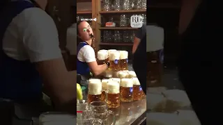Waitress Carries Multiple Heavy  Beer-Filled Mugs Together