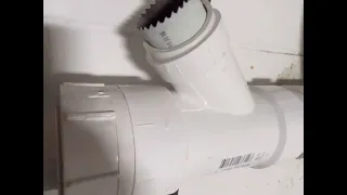 How to remove a glued PVC fitting with heat and a hole saw bit.