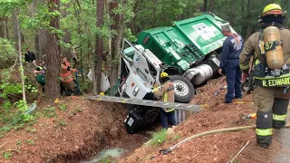 042621 FIREFIGHTERS WORK 2 HOURS TO FREE TRAPPED GARBAGE TRUCK DRIVER