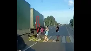 A mother saves her baby by pulling the child out of the way of a speeding lorry crossing in Russia