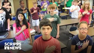 Why do US students pledge allegiance to the flag?