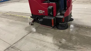 CLEANING A WAREHOUSE FLOOR WITH A RIDE-ON AUTO SCRUBBER