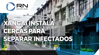 Cercas são erguidas para separar infectados em Xangai