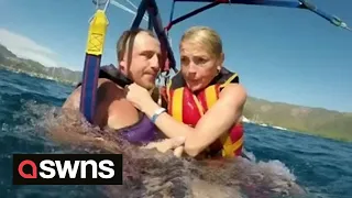British couple's parasail gets tangled sending them crashing into sea off the coast of Turkey | SWNS