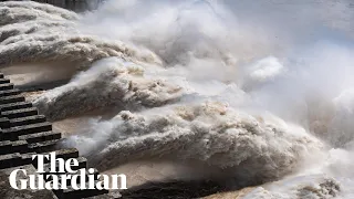 China floods: Three Gorges dam gushes with water while streets are submerged