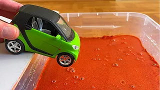 Diecast Cars Sliding Into The Two Boxes Of Water
