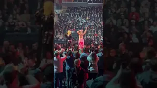 A topless protester interrupted Avril Lavigne on stage