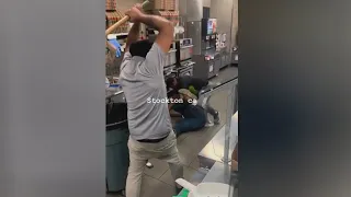 2 workers stop store robbery - caught on camera