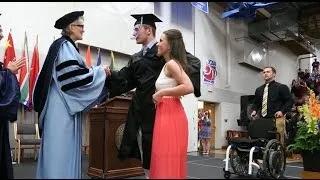 College student paralyzed after football injury walks at graduation