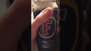 Drinking a can of Fosters Lager beer