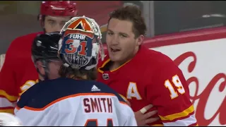 Mike Smith throws a few shots to Matthew Tkachuk during a scrum between the Oilers and Flames