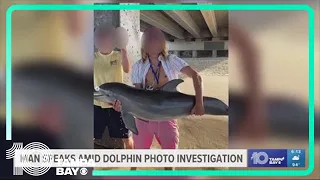 Baby dolphin dead after man takes photo holding it above water