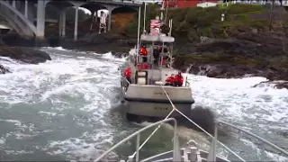 Coast Guard Station Depoe Bay lifeboat tows another lifeboat through "The Hole"