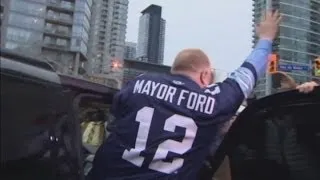 Toronto Mayor Rob Ford poses for photos whilst cheered at football match