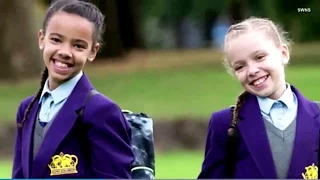 'Million-to-one' Twins, one white, one black. Marcia and Millie off to school for the first time