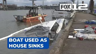 Boat used as house sinks at dock in downtown Portland