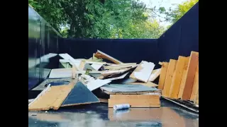 Loading up the 14 yard dumpster on a busy downtown charleston street