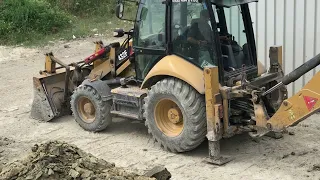 Cat 432F digging a septic pit