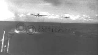 US Navy SB2C Helldiver and F6F Hellcat lands on flight deck of an aircraft carrie...HD Stock Footage