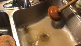 “unclogging” kitchen sink with a PLUNGER (try easiest solution first)