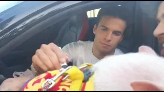 Riqui Puig signing an autograph on a pig