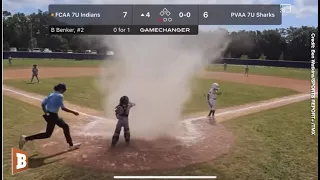 Baseball Umpire Rushes into Dust Devil to Rescue Youth Player