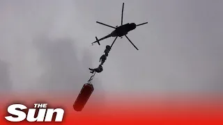 Ukrainian soldiers perform daring aerial drills from combat helicopters