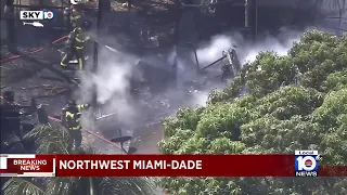 Boat erupts in flames in backyard of home in northwest Miami-Dade