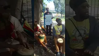 Rastas demonstrating before court house.