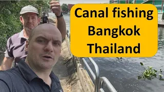 Fishing in a Bangkok Thailand canal. khlong saen saep.คลองแสนแสบ. spear fishing blowgun fishing