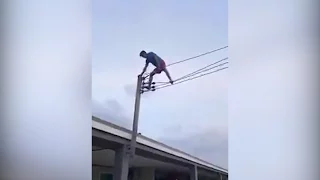 Man climbs on high voltage wire in Miri