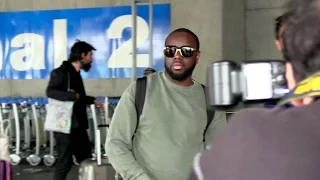 EXCLUSIVE: Maitre Gims and his wife arriving at Cannes airport for the festival