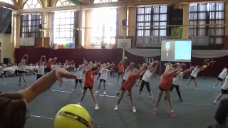 Primary school students practice gymnastics balls