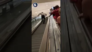 Man Runs Up Lengthy Downbound Escalator as Strangers Cheer Him On