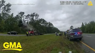 Police cam shows moment car flips over tow truck on highway l GMA