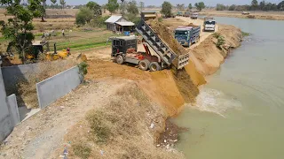 Great Technique Skills Driver Dump Truck Pouring soil Into Water For Expand Additional Road in Canal