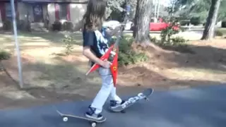 Skateboarder dude plays guitar while skating.