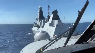Wildcat helicopter landing on board HMS Defender in the Mediterranean