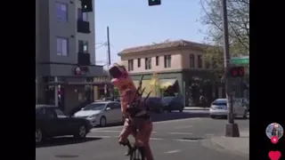 Dinosaur on unicycle while playing bagpipes