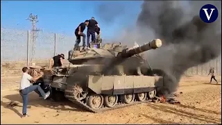 Un tanque israelí en llamas mientras los palestinos cruzan la frontera hacia el sur de Israel