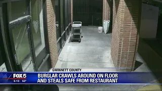 Burglar crawls around on floor and steals safe from restaurant