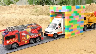 Construction vehicles pass through the magic gate with fire truck and crane truck toys