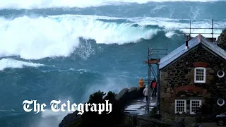 Storm Noa: huge waves crash over Cornish coast as 90mph winds lash UK