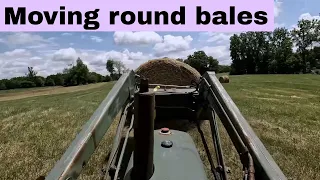 Moving round bales with a small tractor