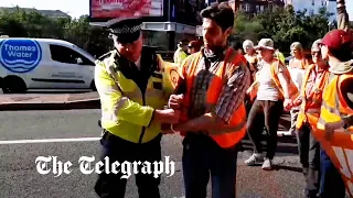 Just Stop Oil protester handcuffed as police crack down on disruptive demonstrations