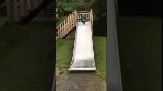 Kid goes down slide then slides across the wet floor | CONTENTbible